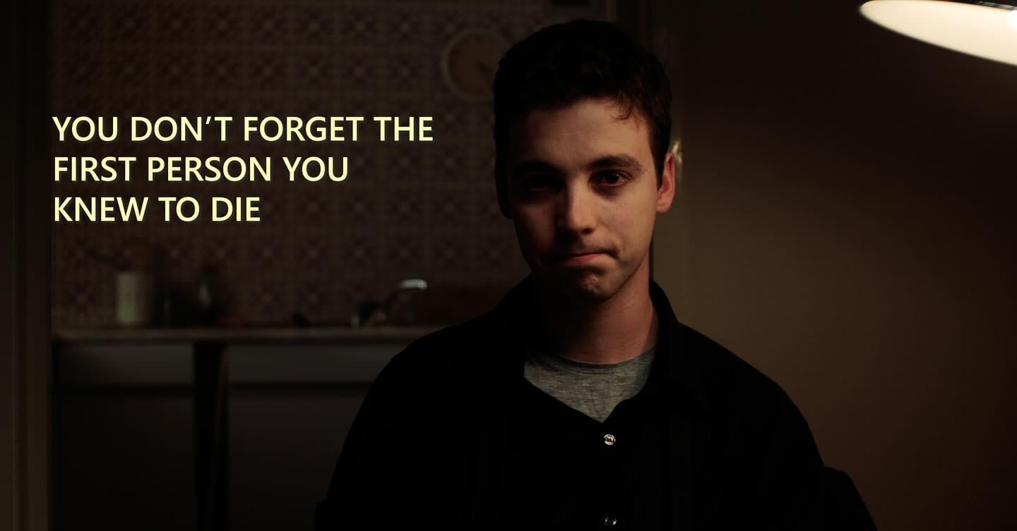 A man stares into the camera with tears in his eyes. Text: 